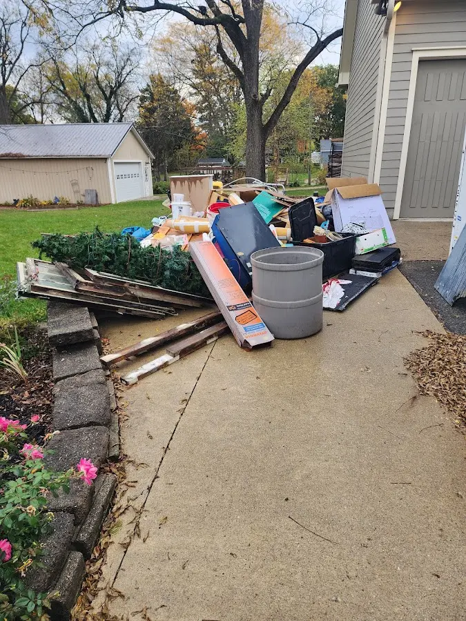 Dumpster being loaded with debris for 12 Yard Dumpster Rental in Fort Shawnee